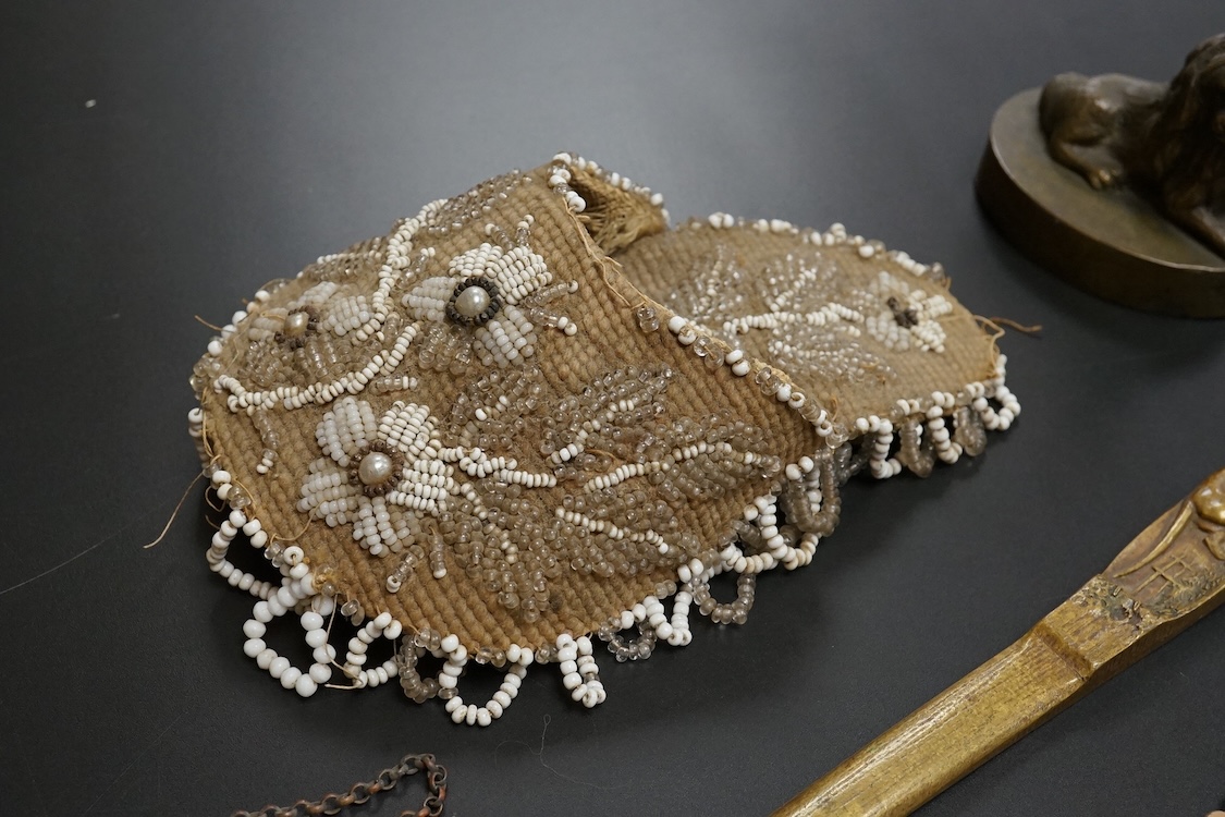 19th century objects to include a bronze lion paperweight, a Palais Royale chamberstick, a beadwork pocket, chatelaine etc